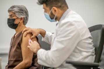 Asian woman receiving vaccine