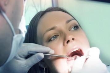 Dentist with white female patient