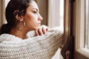 Young woman looking out of a window